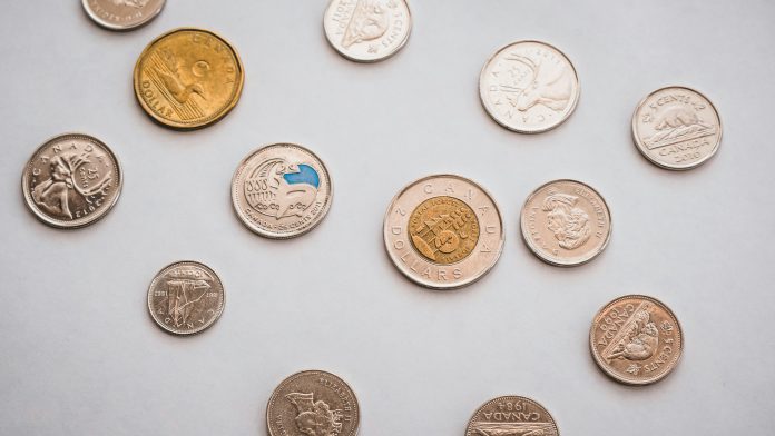 PiggyBank via Unsplash unsplash.com/photos/a-bunch-of-different-types-of-coins-on-a-table-8Wwft7EYzFg)